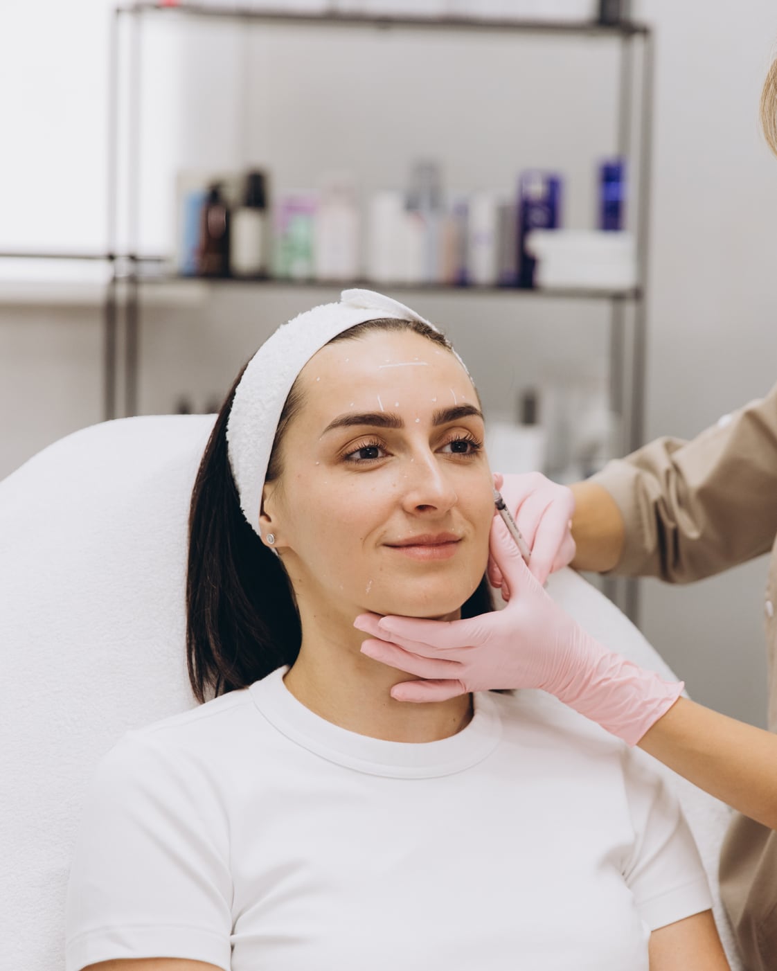 A practitioner treating a client at a beauty clinic